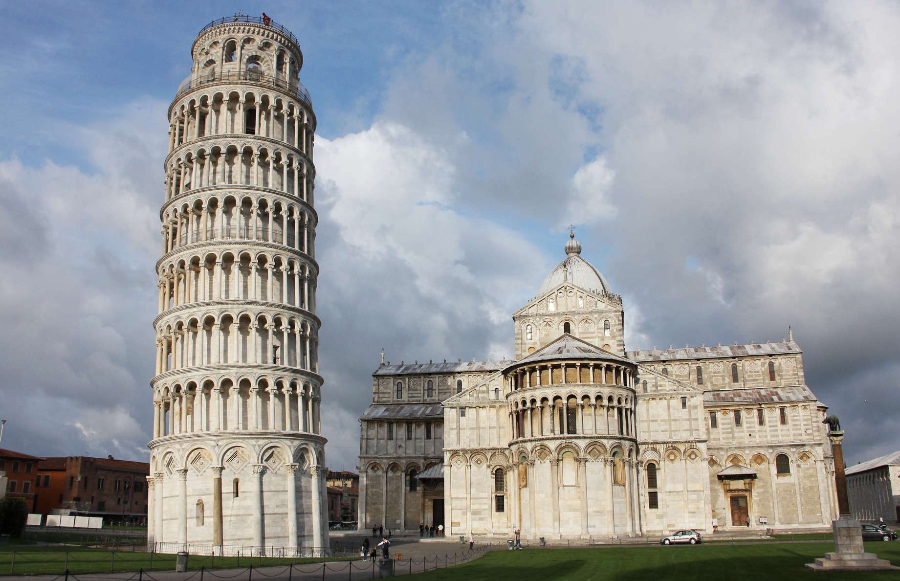Piazza dei Miracoli. The construction of the campanile of the Duomo di Pisa started in the 1170s and took about 200 years. Due to soft ground on one side, the tower started to incline already during construction. The movement continued afterwards, until stabilization works took place in the late 20th and early 21st Century. The cathedral and its campanile are both examples of Romanesque-Style architecture. WI_e2104_001.JPG