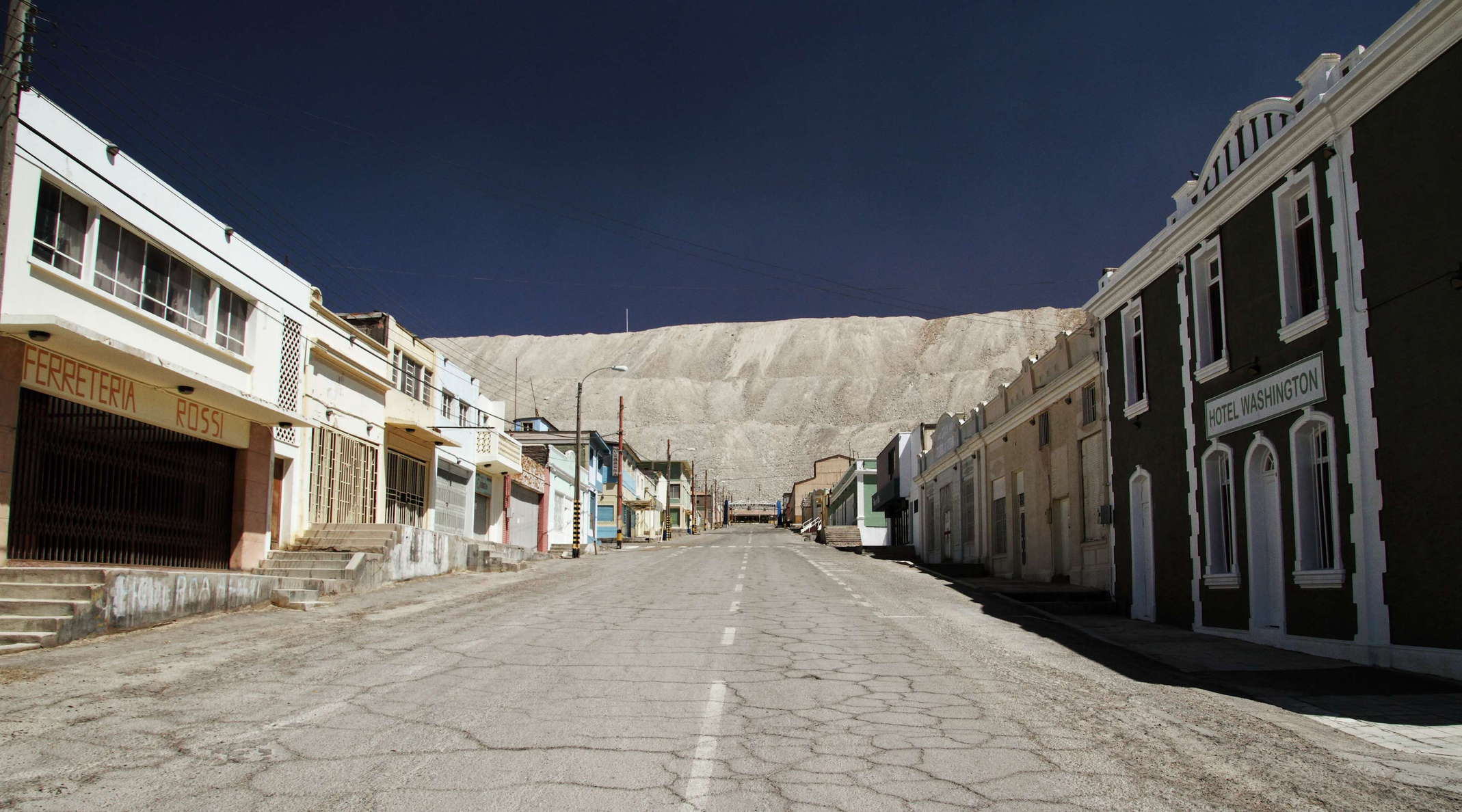 The mining town has hosted the workers of the copper mine of Chuquicamata for many decades. In the early days it was representing a very much closed system, providing many facilities but also keeping the miners dependent on the company. The town was abandoned in 2007 due to health and safety concerns. The inhabitants were resettled to the nearby city of Calama. WI_ch330f.jpg