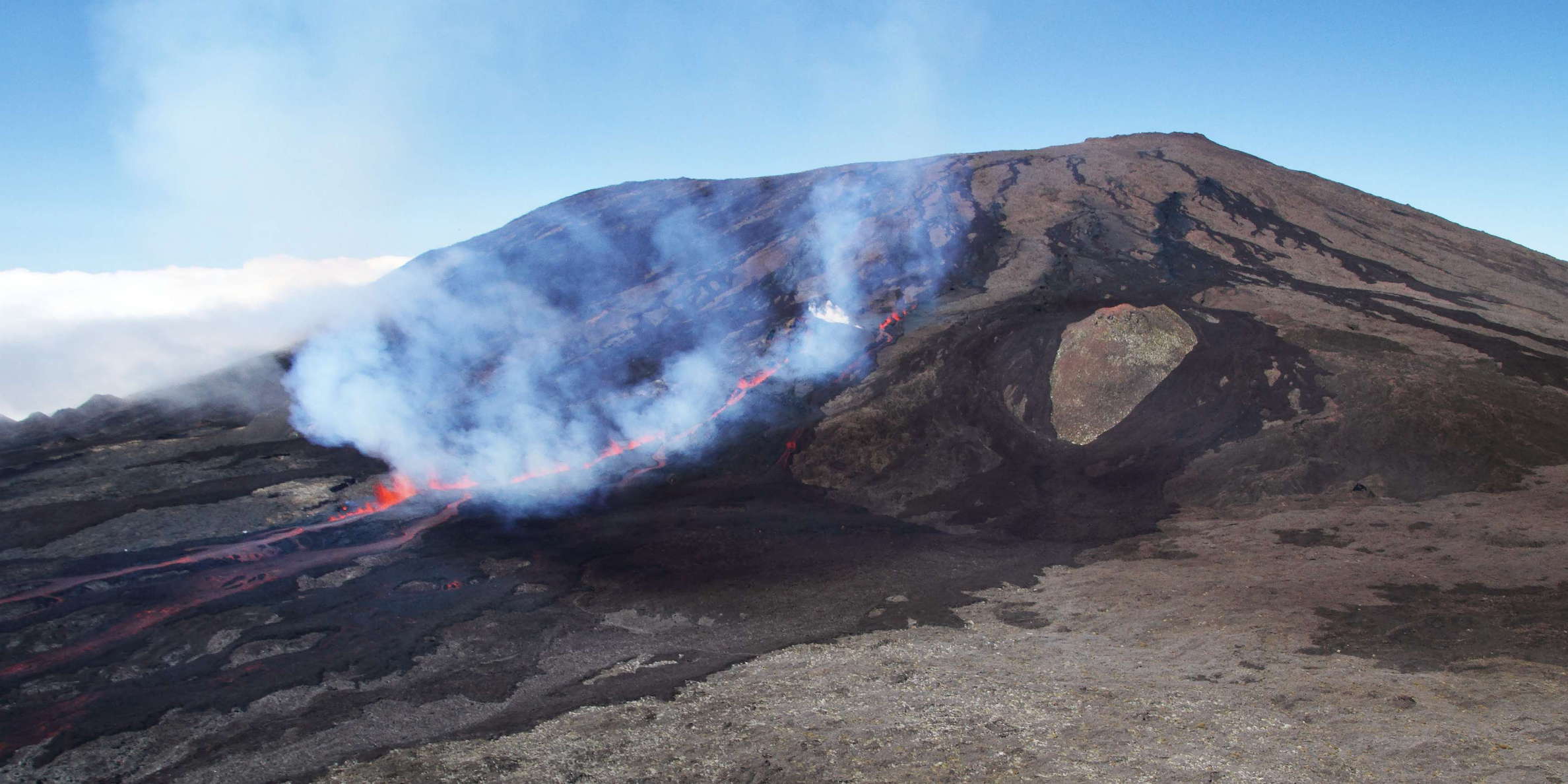 Viewpoint at the Rempart de Bellecombe between Piton de Partage and Nez Coupé de Sainte-Rose. The summit cone (2632 m) with the rim of Cratère Bory is seen in the upper right portion of the photograph, taken 4:47 hours after the start of the fissure eruption. WI_re142.jpg