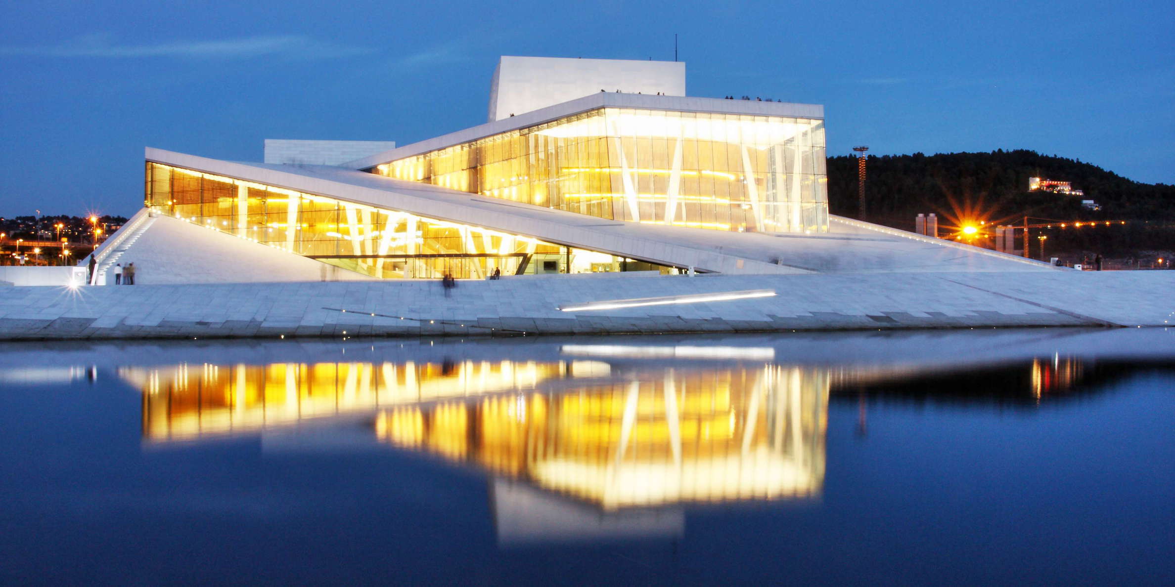 Nighttime view of the national opera theatre, home of the Norwegian National Opera and Ballet. Located at the head of the Oslofjord, this venue has opened its gates in April 2008. The building's exterior surfaces are covered with white granite and carrara marble. WI_no015.jpg