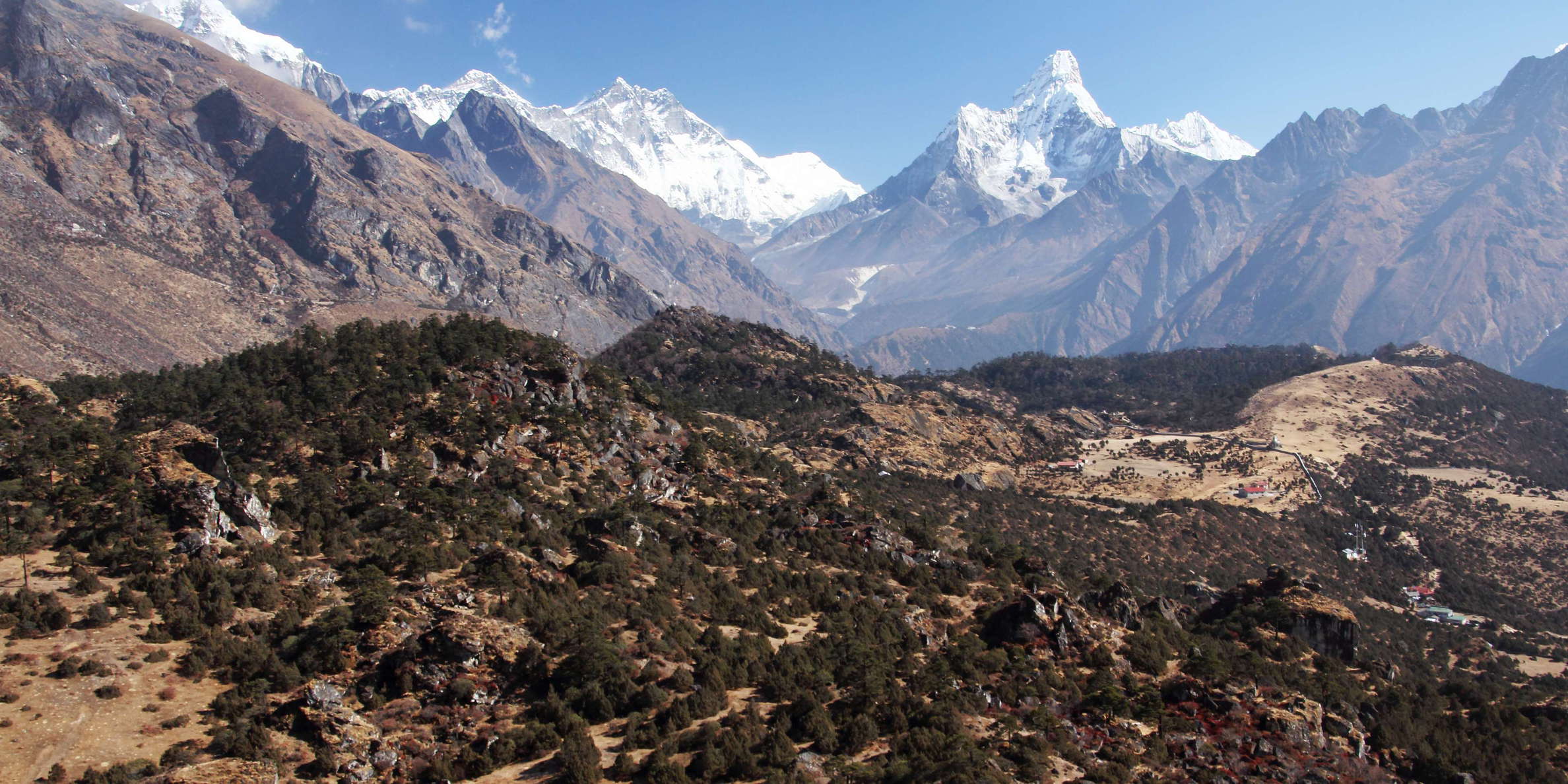 This photograph shows part of the deposit of a huge ancient rock slide. Mt. Everest (8848 m), Lhotse (8516 m), and Ama Dablam (6812 m) appear in the background in northeastern direction. WI_np089d.jpg