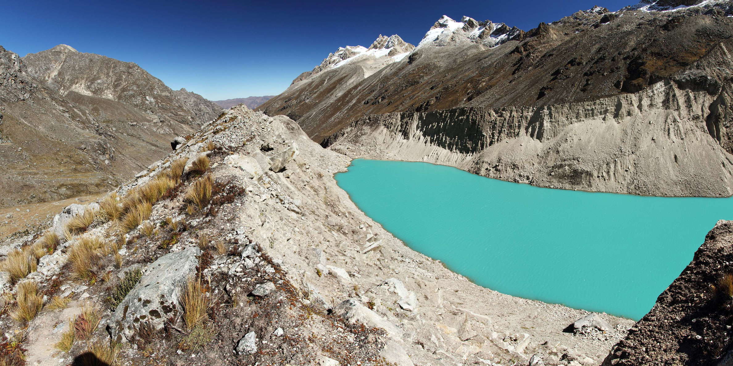 In 1952, almost the entire trough between these moraine ridges was filled by a glacier tongue, with a small proglacial lake at the front. That lake drained suddenly, the flood eroding a deep breach into the terminal moraine. Since then, the lake has redeveloped to a much larger size - however, at a lower level - due to the retreat of the parent glacier. WI_pe038_509.jpg