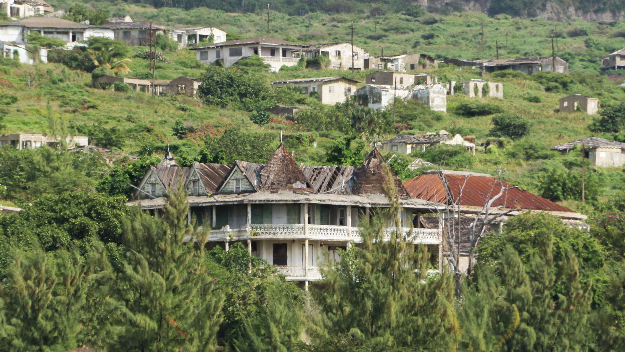 The capital of Montserrat was permanently evacuated in 1996 after the nearby Soufrière Hills Volcano had reactivated. Since then it has been almost completely buried in pyroclastic flows and lahars. The buildings in the suburb of Town Hill still exist, but fell into disrepair as the entire southern portion of the island remains an exclusion zone. WI_la416.jpg