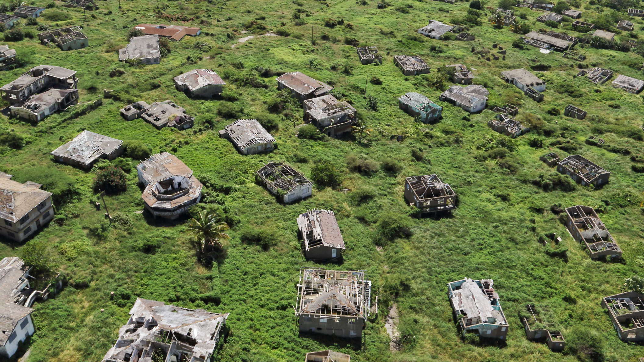The capital of Montserrat was permanently evacuated in 1996 after the nearby Soufrière Hills Volcano had reactivated. Since then it has been almost completely buried in pyroclastic flows and lahars. The buildings in the suburb of Town Hill still exist, but fell into disrepair as the entire southern portion of the island remains an exclusion zone. WI_la419.jpg