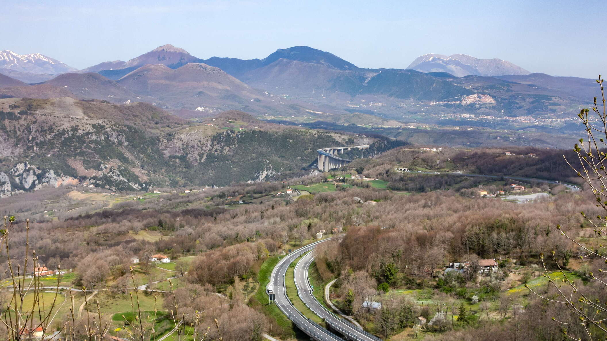 View from the National Road 504 in northwestern direction. The motorway is the A2 (former A3) with Viadotto Italia in the upper centre of the photo, whereas Monte Sirino (2005 m) can be seen in the right central background. WI_e2136r.JPG