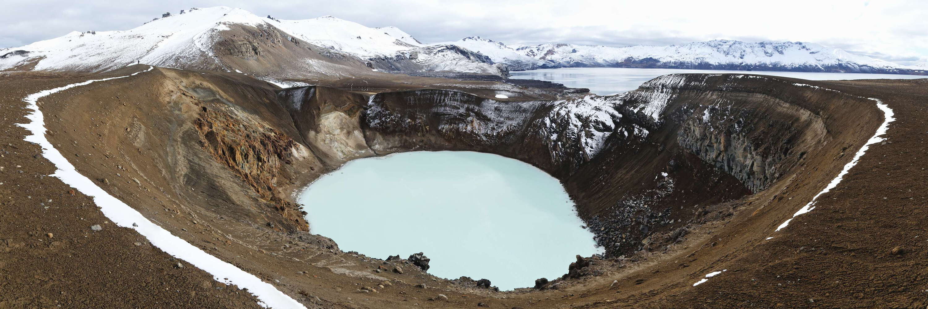 Askja represents a volcanic system with nested calderas north of Vatnajökull. A major eruption in 1875 resulted in the formation a huge caldera which was later filled by lake Öskjuvatn (right background), 11 square kilometres large and more than 200 m deep. The small geothermal lake Víti (in the foreground) fills an explosion crater that goes back to the same eruption. It has a temperature of 20-30 degrees Centigrade. The main crest of the mountain range Dyngjufjöll (1510 m) appears in the very background. WI_is162.jpg