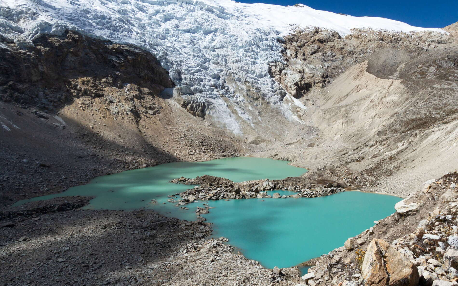 This lake in the headwaters of the Ishinca Valley occupies a basin formerly filled by the glacier which has now retreated to the steep rock walls in the background. WI_pe038_511a.jpg