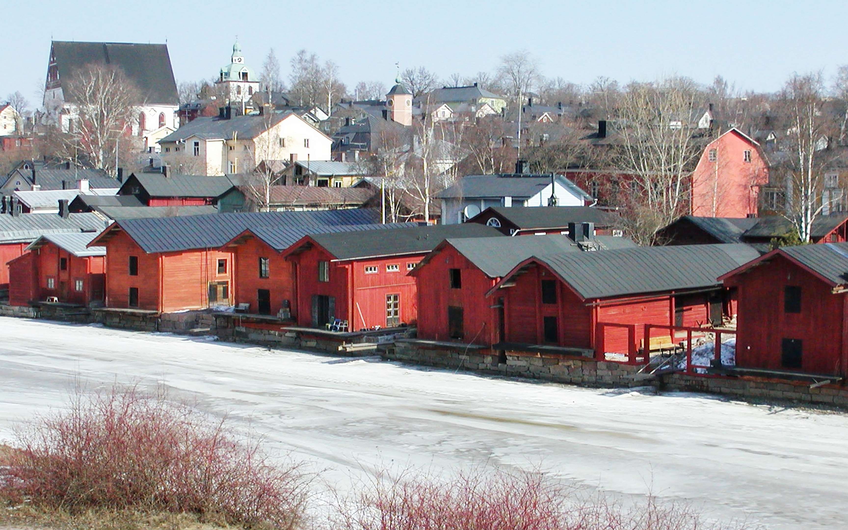 View from Uusi Bridge in northern direction across Porvoonjoki - still covered with ice - to the old town of Porvoo. An ensemble of riverside storage buildings dominates the centre of the photograph. The cathedral with its separate bell tower appears in the left background, whereas the tower of the town hall can be seen in the central background. WI_fi008.jpg